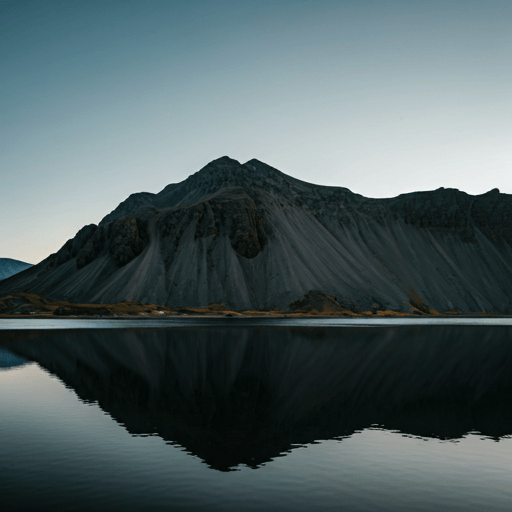 Dark mountain range with water reflection
